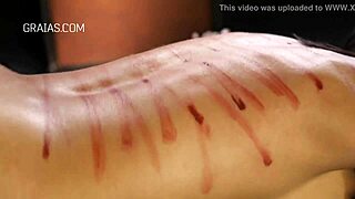Femdom mistress punishes her crimson-haired sub with a whip