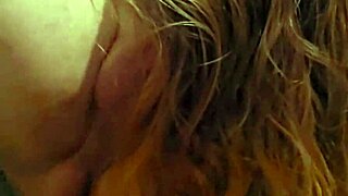 Sexual woman with fiery hair deeply engaged in passionate oral play