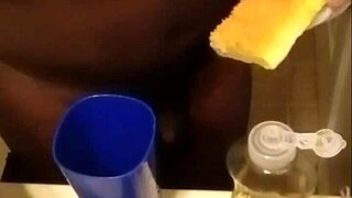 Washing dishes while standing on rugs close up cock