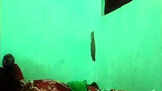 Khmer girl relaxes on the bed in her bedroom.