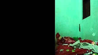 Khmer girl relaxes on the bed in her bedroom.