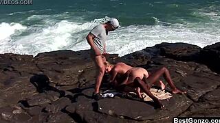 Hey, check out this ocean threesome with busty blonde Tarra White sucking big black cock outdoors.