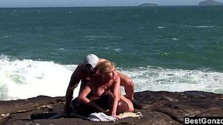 Hey, check out this ocean threesome with busty blonde Tarra White sucking big black cock outdoors.
