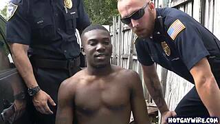 two police officers in uniform taking advantage of black guy at work