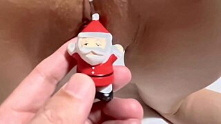 Santa Claus teasing a shaved Asian pussy with a dildo close up