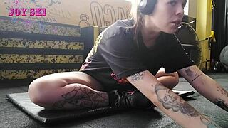 Alternative Girl Stretches At The Gym.