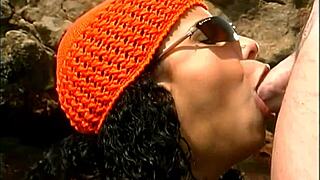 yo, watch this mature guy bang an exotic babe by the seaside rocks