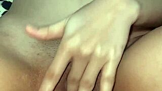 This young babysitter fingers her wet pussy in close up view.