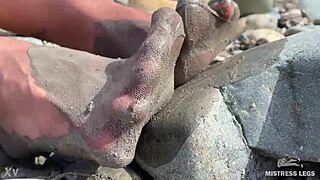 i show you my messy nylon feet close-ups in torn pantyhose on the river bank.