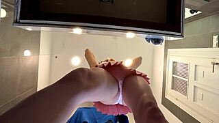 Is this braless brunette showing her ass and legs in the bathroom?