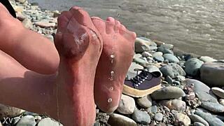 i show you my messy nylon feet close-ups in torn pantyhose on the river bank.