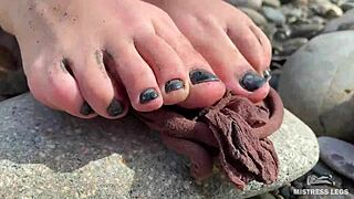 i show you my messy nylon feet close-ups in torn pantyhose on the river bank.