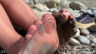 i show you my messy nylon feet close-ups in torn pantyhose on the river bank.