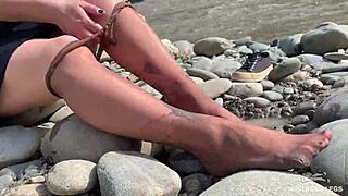 i show you my messy nylon feet close-ups in torn pantyhose on the river bank.