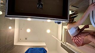 Is this braless brunette showing her ass and legs in the bathroom?