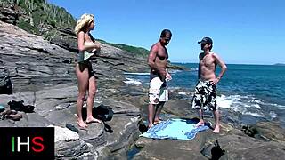 Blonde girl bent over, getting licked and fingered before double penetration at the seaside.