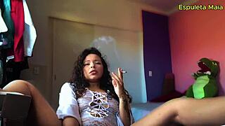 The hot brunette is sucking while smoking. She masturbates in lingerie.