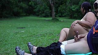 I masturbate outdoors in a public park while a woman watches me.