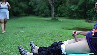 I masturbate outdoors in a public park while a woman watches me.