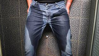Guy wets his jeans with pee and gets a cumshot outdoors