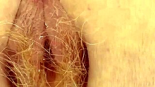 a redhead with hairy pussy pees through her red hair in this intimate scene