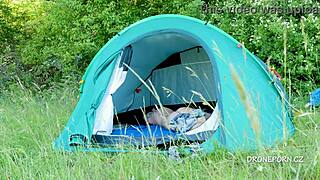 This nudist milf relaxes in the tent at the beach
