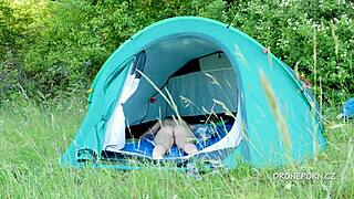 This nudist milf relaxes in the tent at the beach