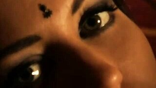 The mature Indian brunette stands confidently in her stylish black dress.