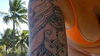 Girl flashes tits to buy items on beach.