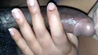 She strokes black cock spit