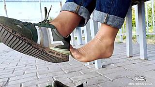 tan nylon soles in blue jeans tease on the outdoor bench