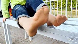 tan nylon soles in blue jeans tease on the outdoor bench