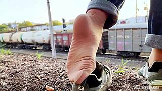 tan nylon soles in blue jeans tease on the outdoor bench