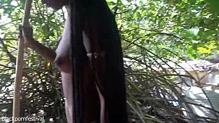 Skinny tribe woman prepares bow for hunting