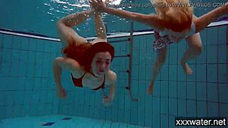 Russian girls in bikinis swimming and playing underwater in the pool