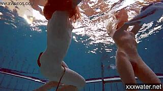Russian girls in bikinis swimming and playing underwater in the pool