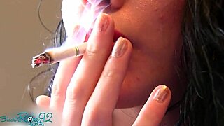 Experienced housewife smokes with matte red lipstick on