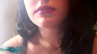 Experienced housewife smokes with matte red lipstick on