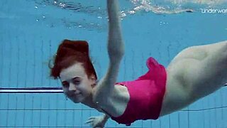 anna netrebko is swimming softly in the pool underwater