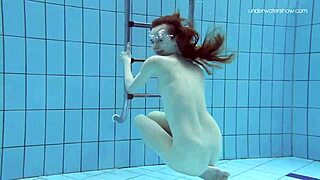 anna netrebko is swimming softly in the pool underwater