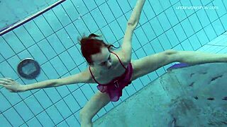anna netrebko is swimming softly in the pool underwater