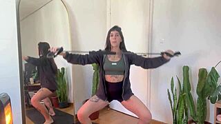 Inked girl does rubber band workout warm-up for strength and yoga fitness