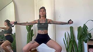 Inked girl does rubber band workout warm-up for strength and yoga fitness