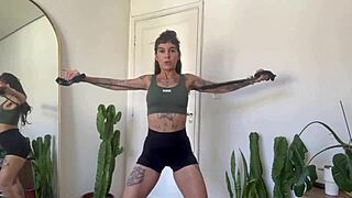 Inked girl does rubber band workout warm-up for strength and yoga fitness