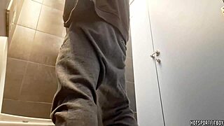 Sexy guy masturbating his monster cock in a public bathroom riskily