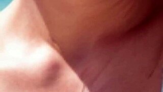 mature model strolls beach in suggestive pose