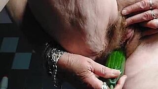 granny stuffs cucumber deep into hairy mature german beaver pussy