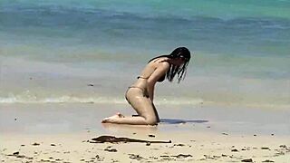 She Teases Her Curves on Caribbean Beach in Tiny Bikini