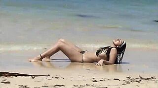 She Teases Her Curves on Caribbean Beach in Tiny Bikini