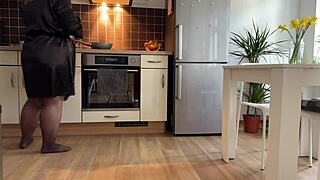 Chubby mother-in-law fingers wet pussy in kitchen craving hot cum on fat ass